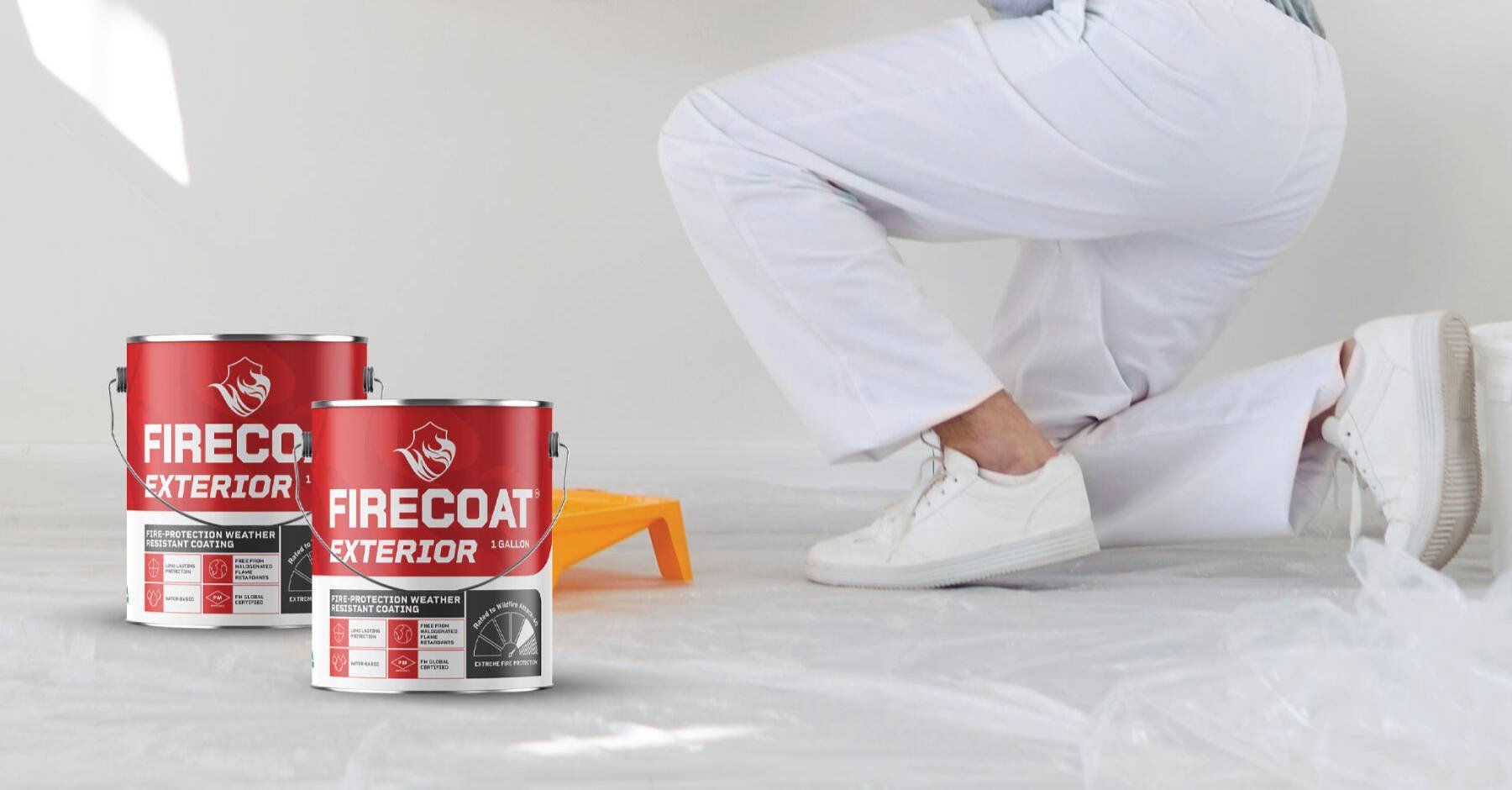 FIRECOAT fireproof paint cans beside a person in white workwear on a covered floor