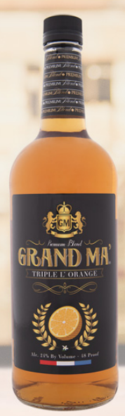 A bottle of grand mal triple sec sits on a table