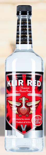 A bottle of kur red vodka with a red label