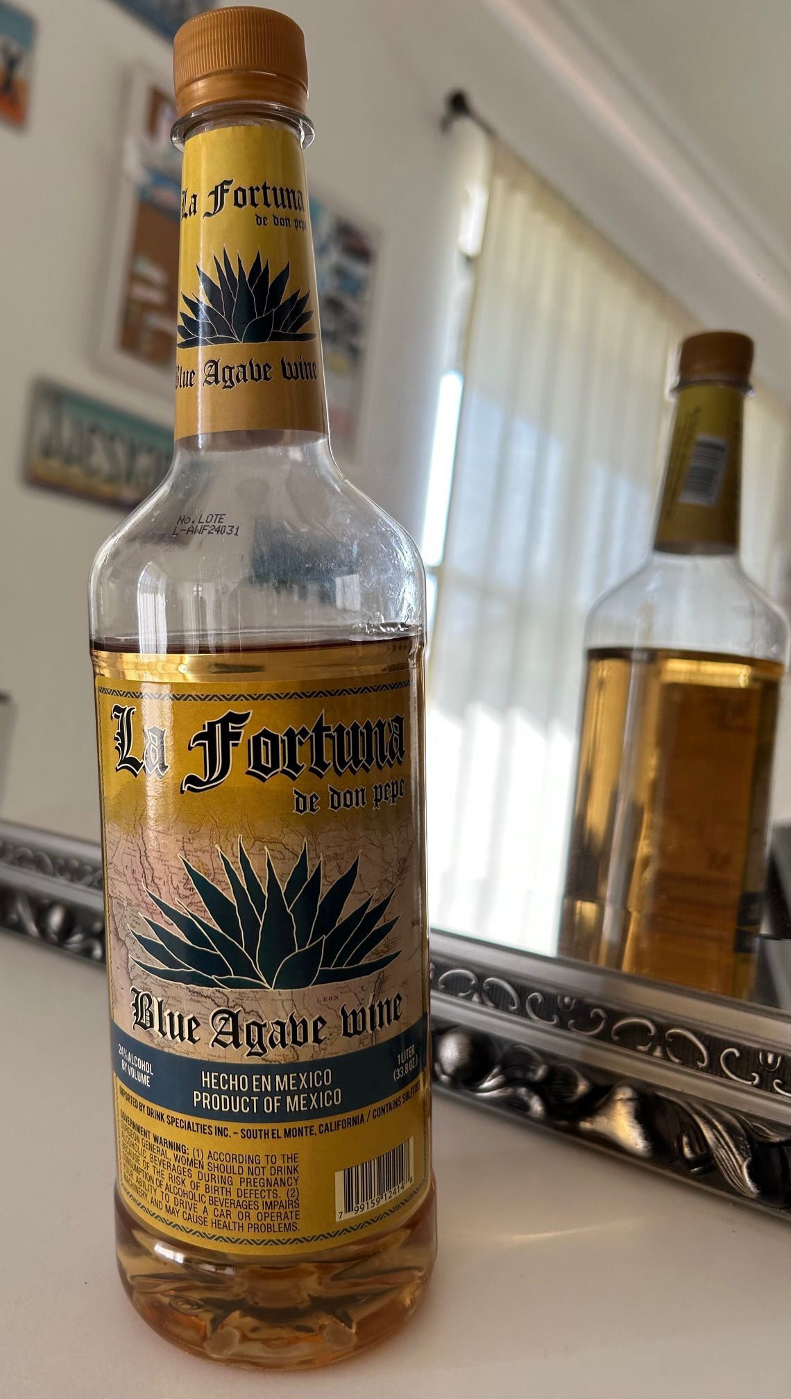 A bottle of tequila is sitting on a table.