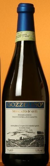 A bottle of wine with a white label and a blue cap