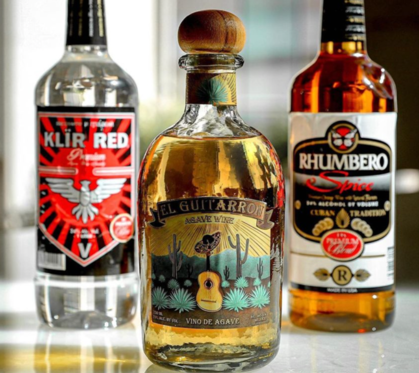 Three bottles of liquor including el guitarro and rhumbero