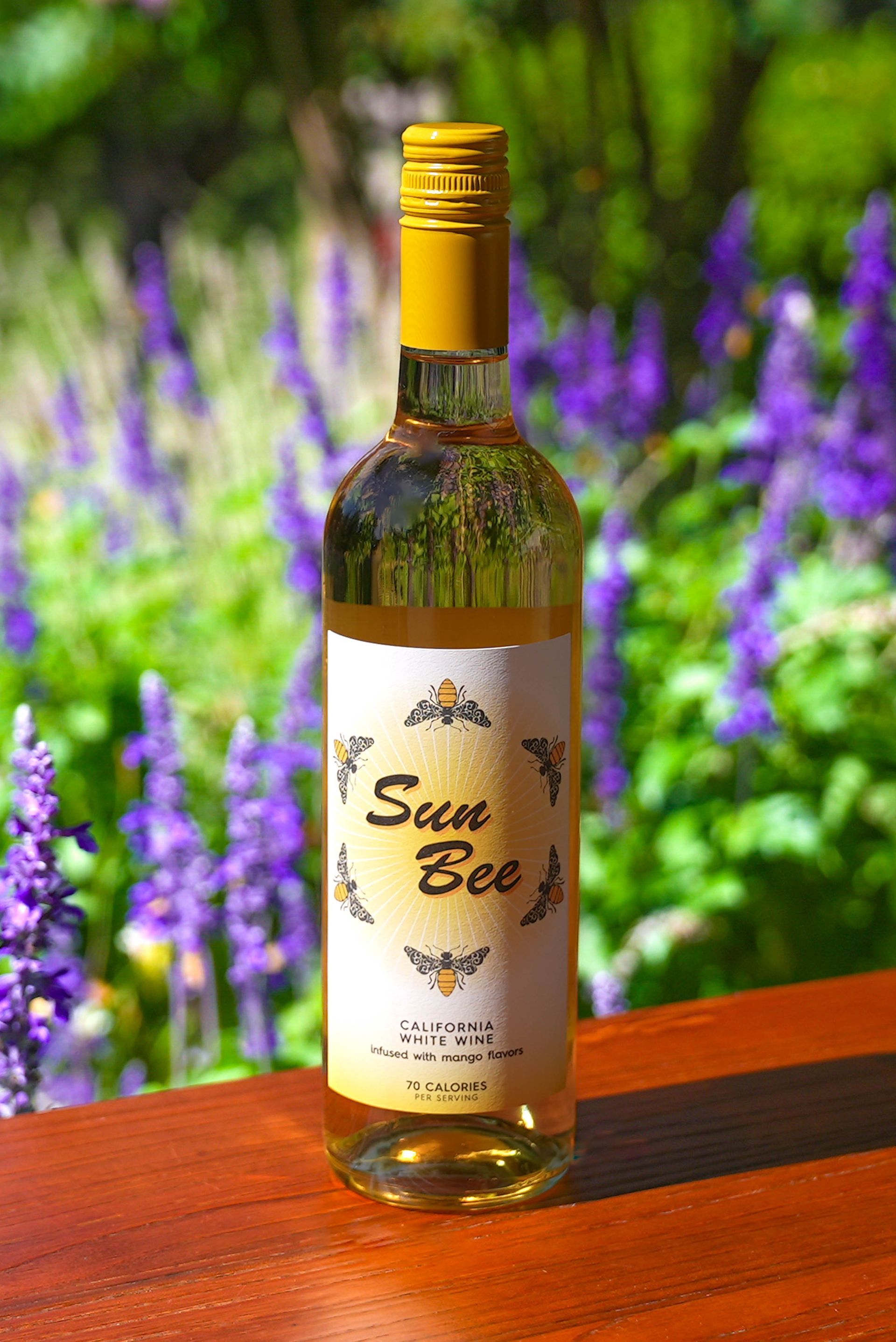 A bottle of sun bee wine is sitting on a wooden table.