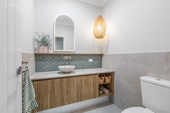 Custom bathroom vanity with fluted timber cabinetry and open shelving, crafted by cabinet makers in Mackay