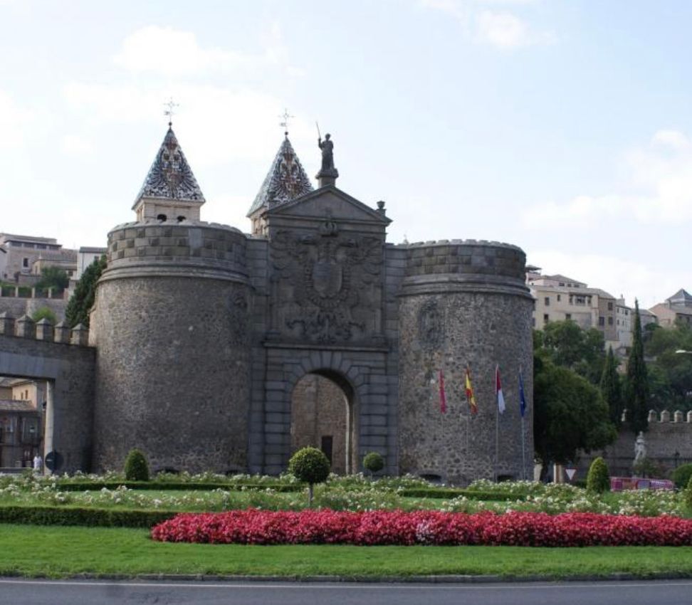 A large stone building with a statue on top of it