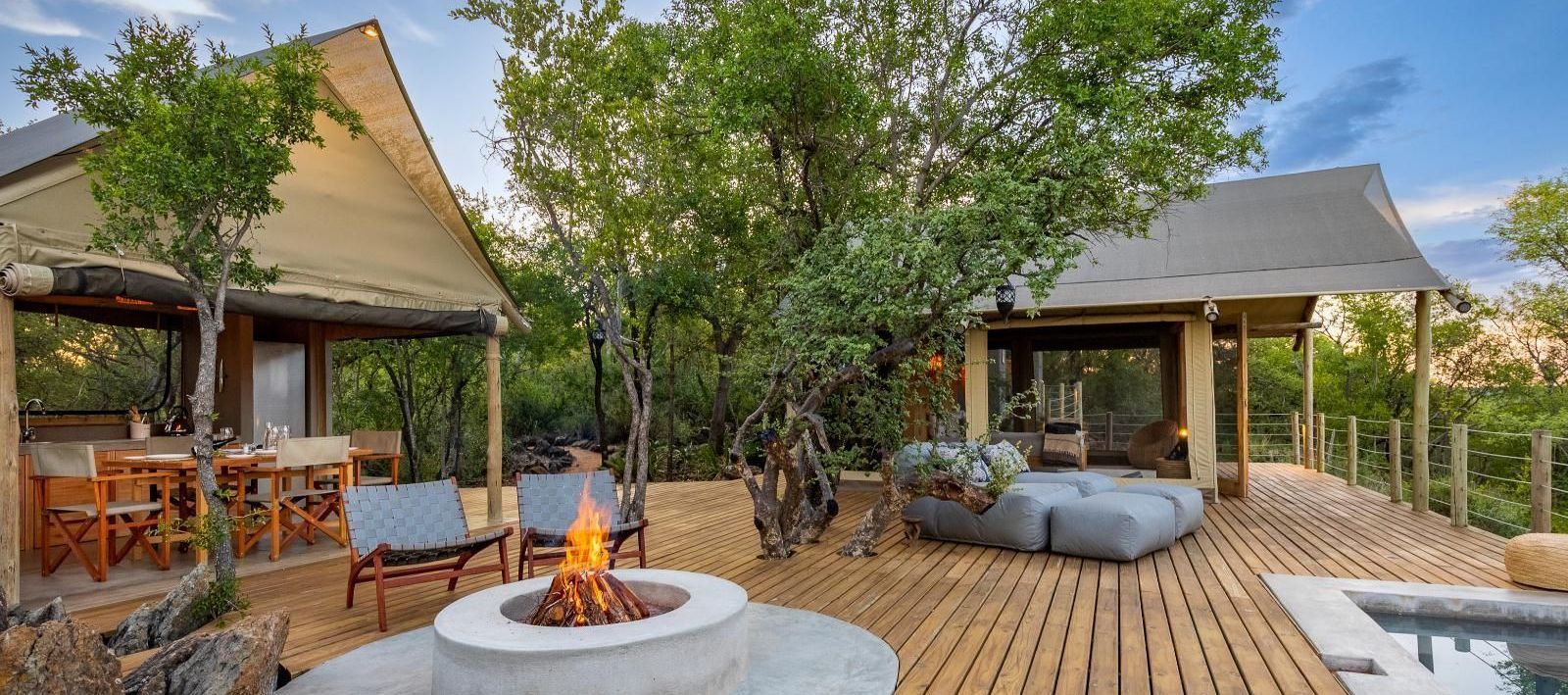 there is a fire pit on the deck of a house .