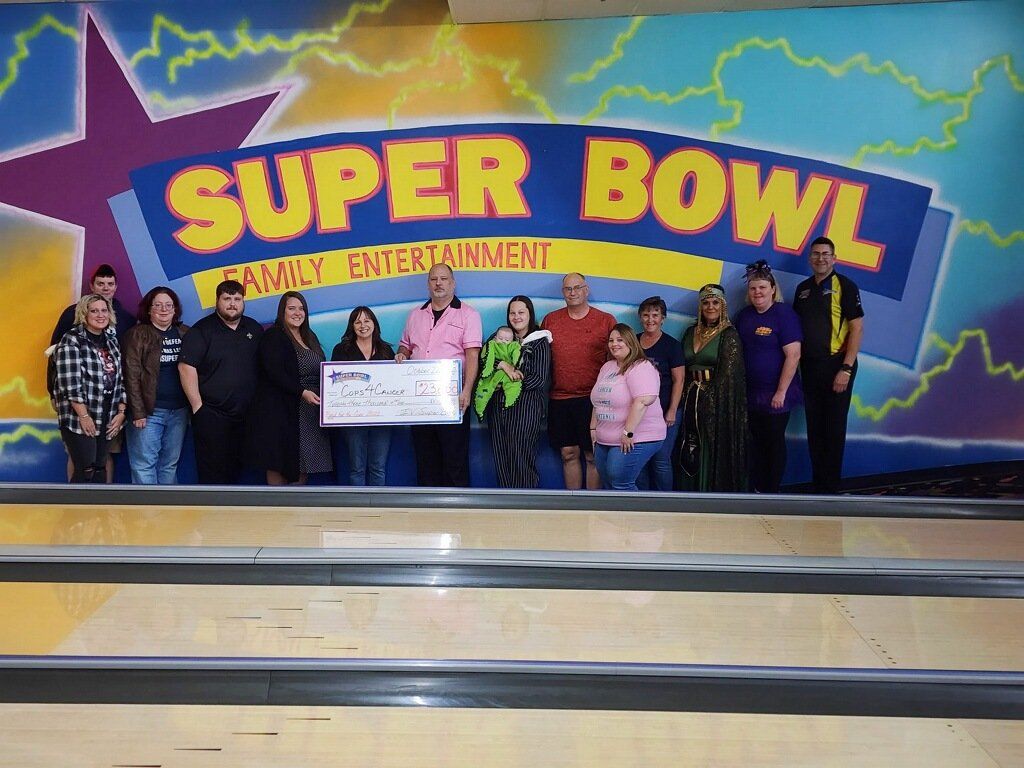 A group of people standing in front of a sign that says super bowl