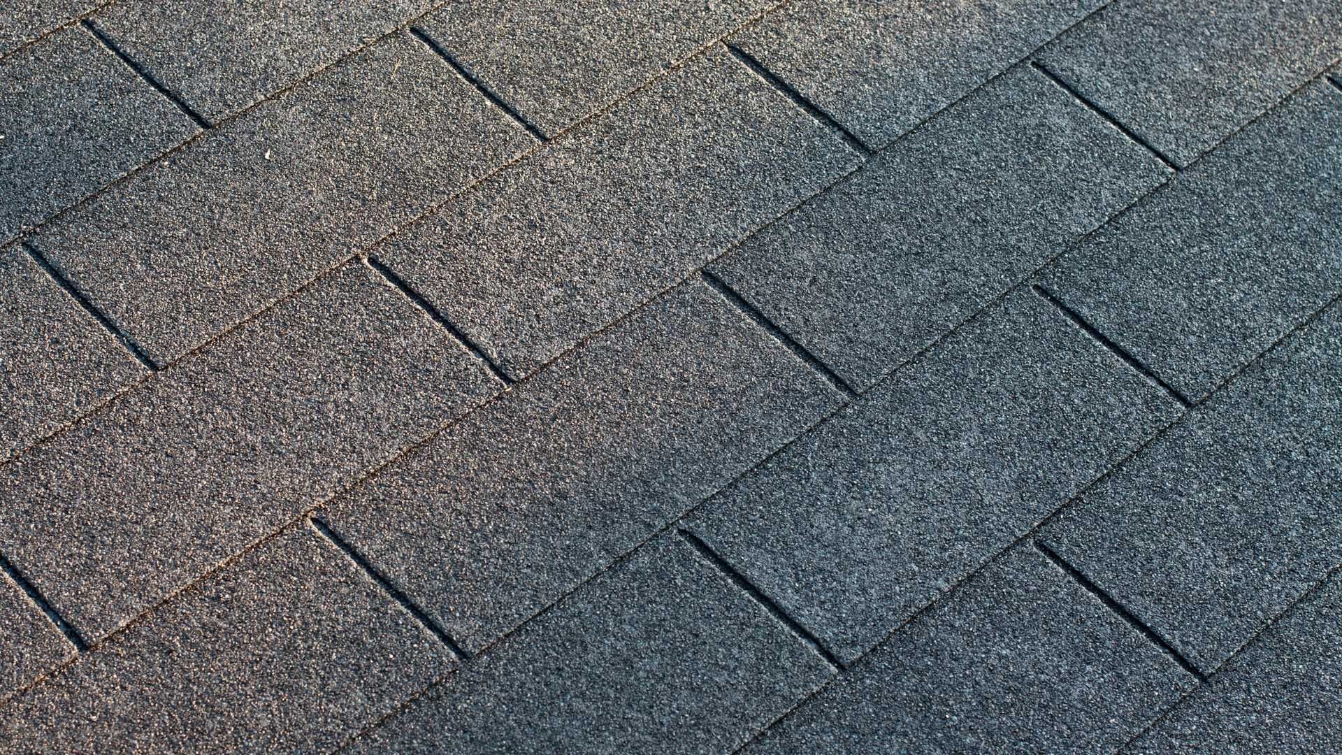 A close up of a roof with a lot of shingles on it.