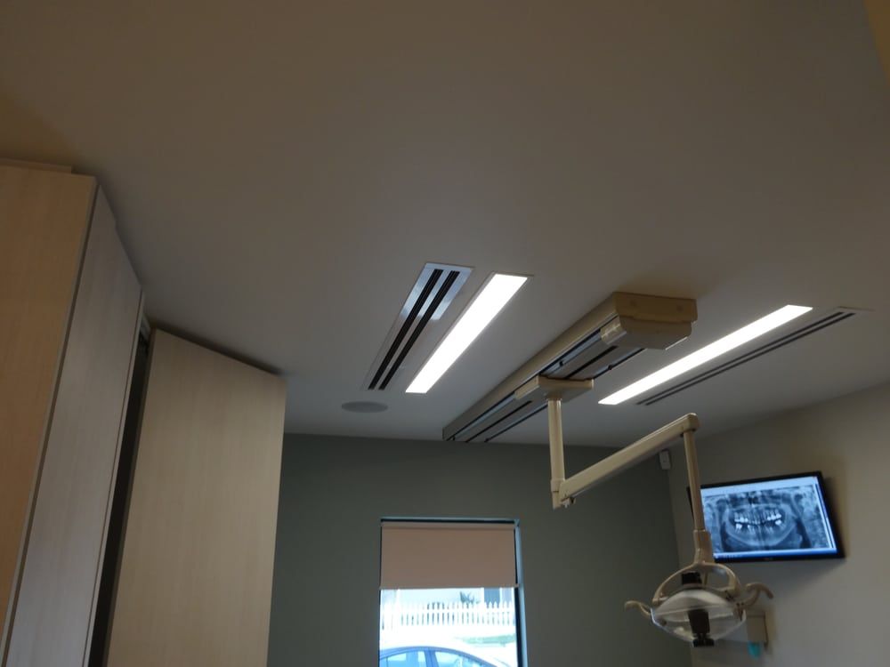 A dental room with a monitor on the wall