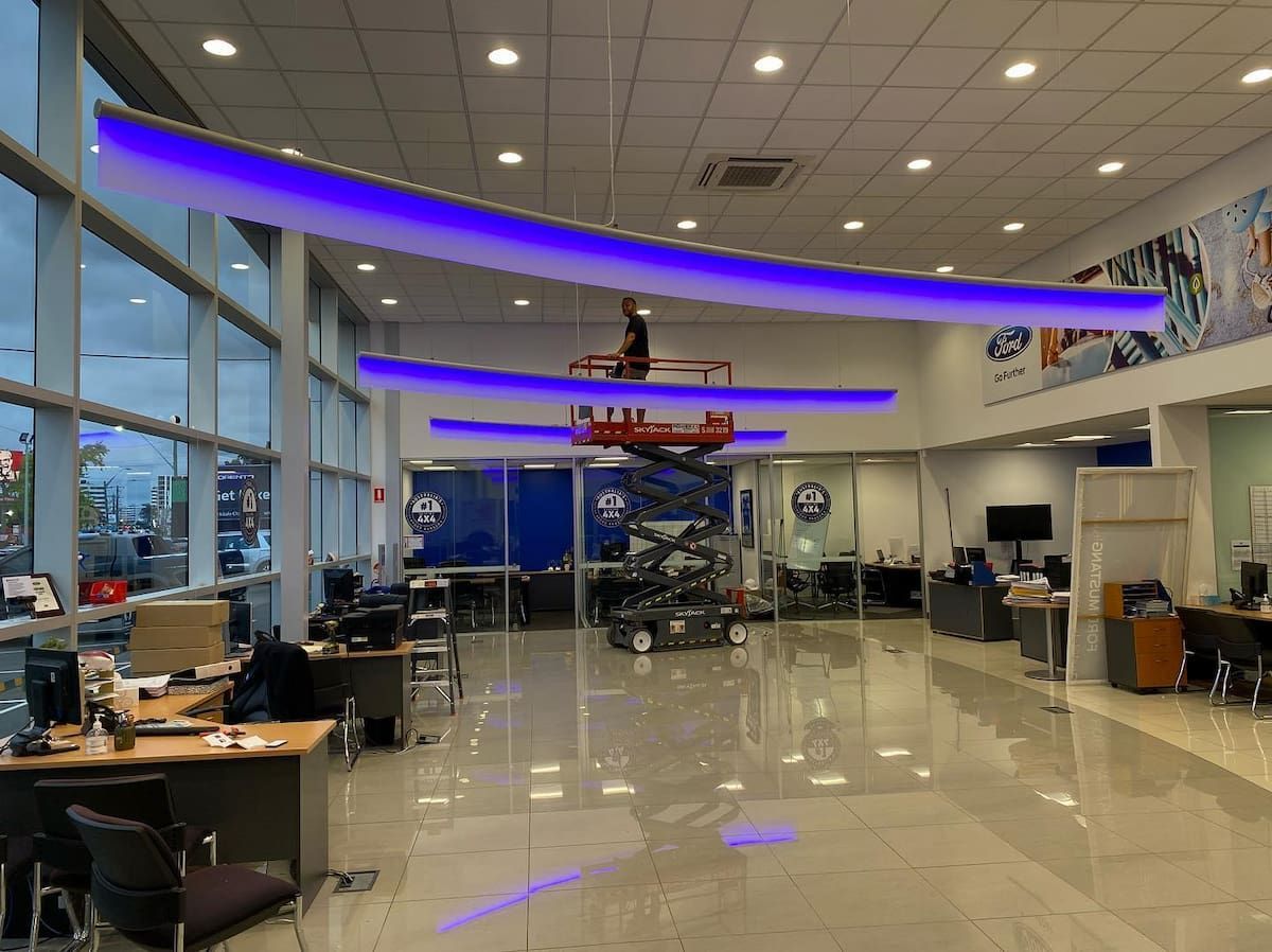 Interior of a Showroom With Blue Neon Lights Hanging From the Ceiling — Hspark Electrical PTY LTD in Austinmer, NSW