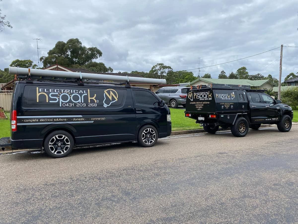 Black Electrical Service Vans Parked on Street — Hspark Electrical PTY LTD in Woonona, NSW