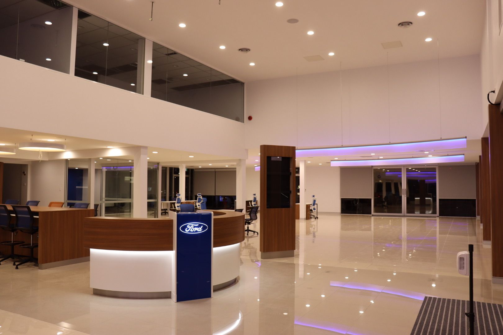 A clean, modern Ford dealership lobby with a reception desk, polished floors, and bright lighting — Hspark Electrical PTY LTD in Narellan, NSW