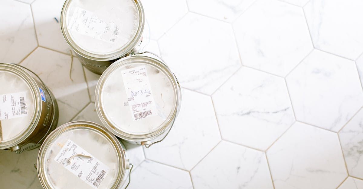 Bathroom renovation material samples – white hex tile and paint cans for bathroom remodel design planning in Santa Fe, NM