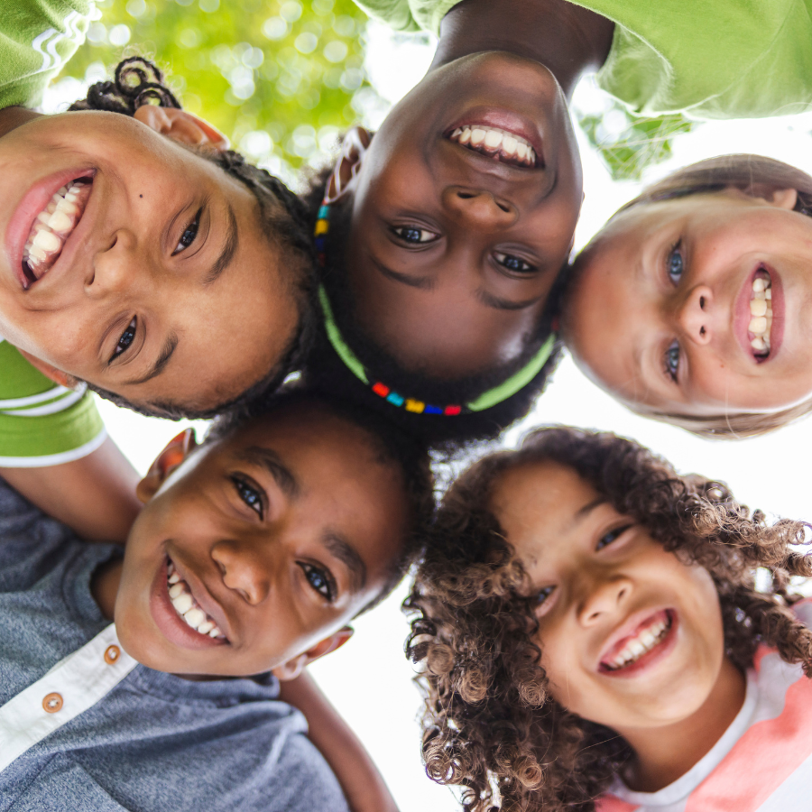 A group of children from Tarrytown, NY  standing in a circle and smiling at the camera
