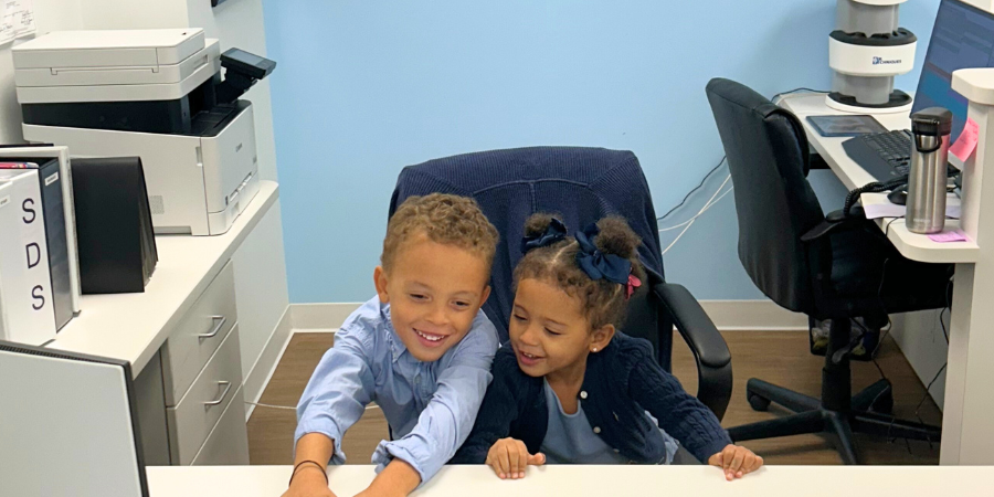 Dr Mensah's children pretending to work in the front office, pediatric dentist near Irvington NY