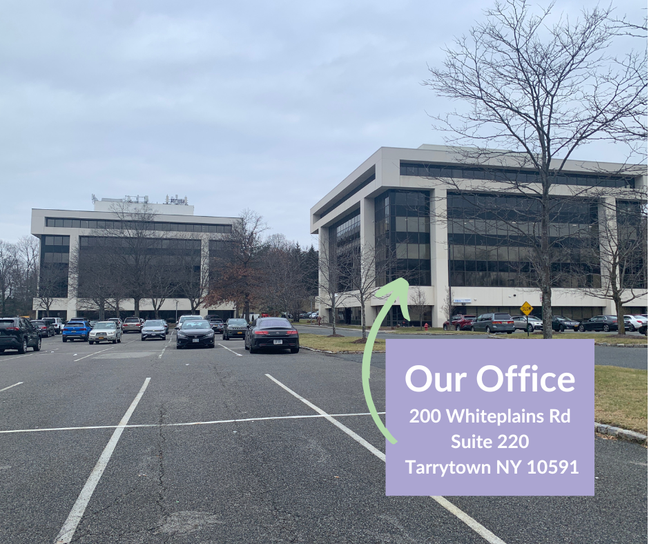A parking lot with a sign that says our office 200 whiteplains rd suite 220 tarrytown ny 10591 