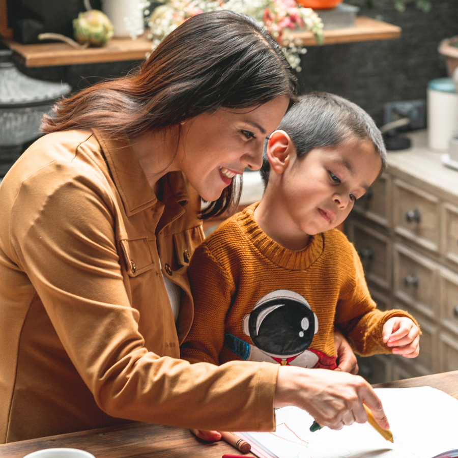 Parent teaching her autistic son about the dentist