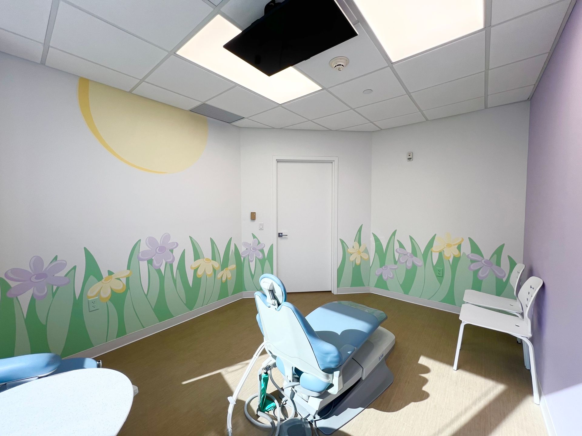 Pediatric dentist treatment room in Hastings-On-Hudson featuring dental chair, playful wall art, and child-friendly design at Next Level Pediatric Dentistry.