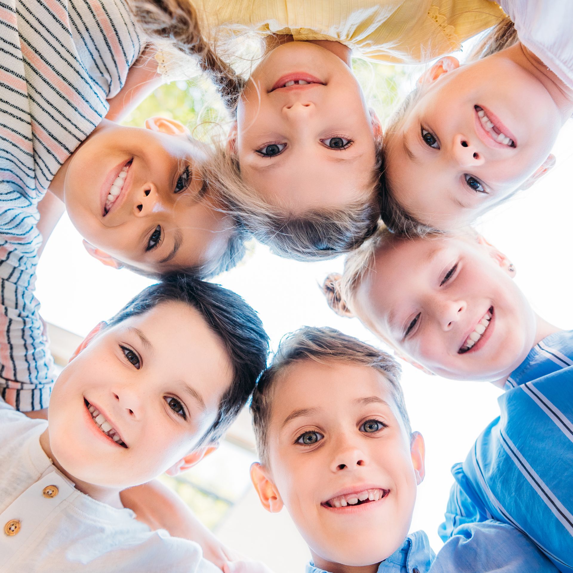 A group of children from Tarrytown, NY standing in a circle and smiling at the camera