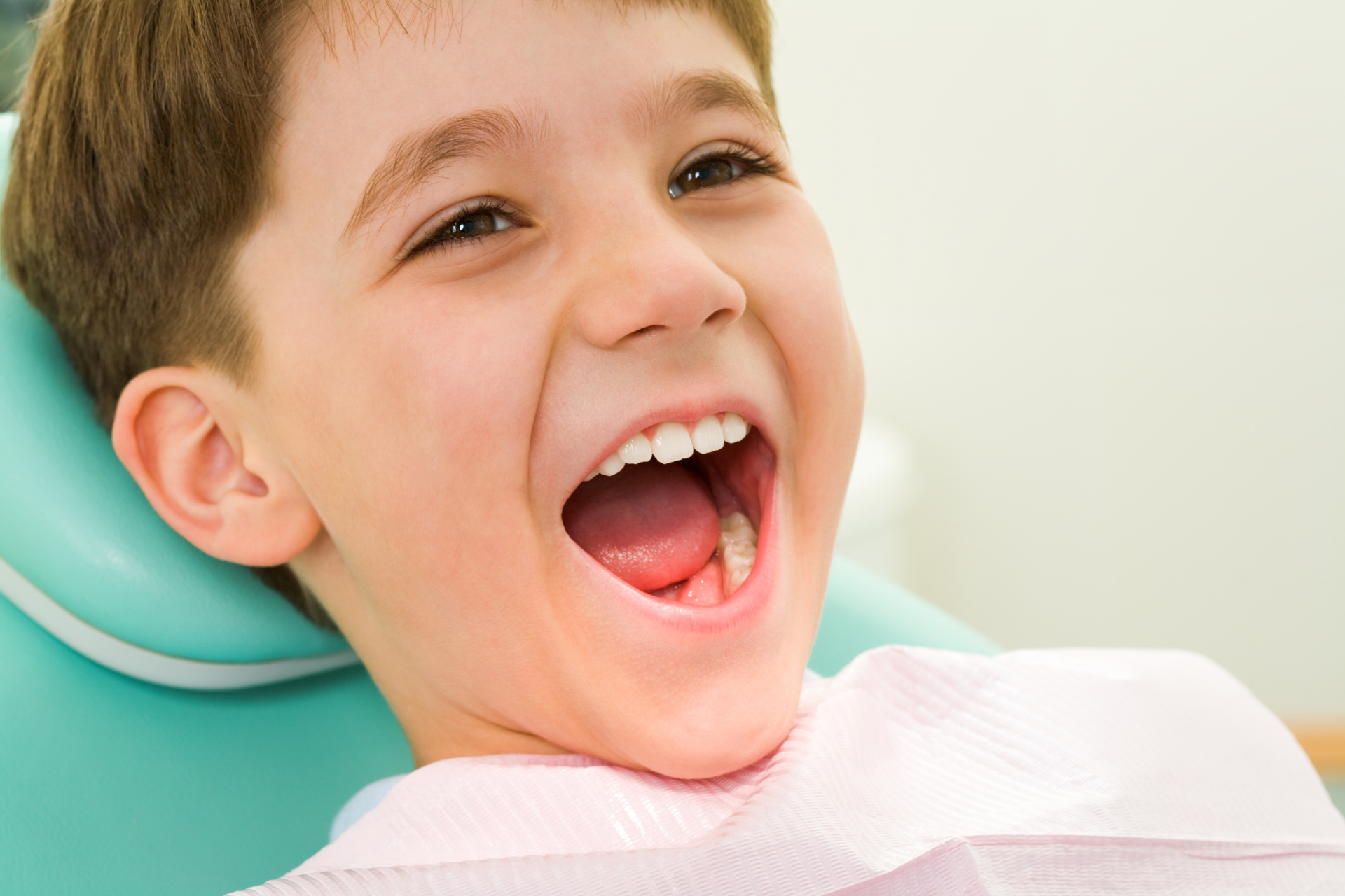 Boy with mouth open in dentist chair in Tarrytown NY