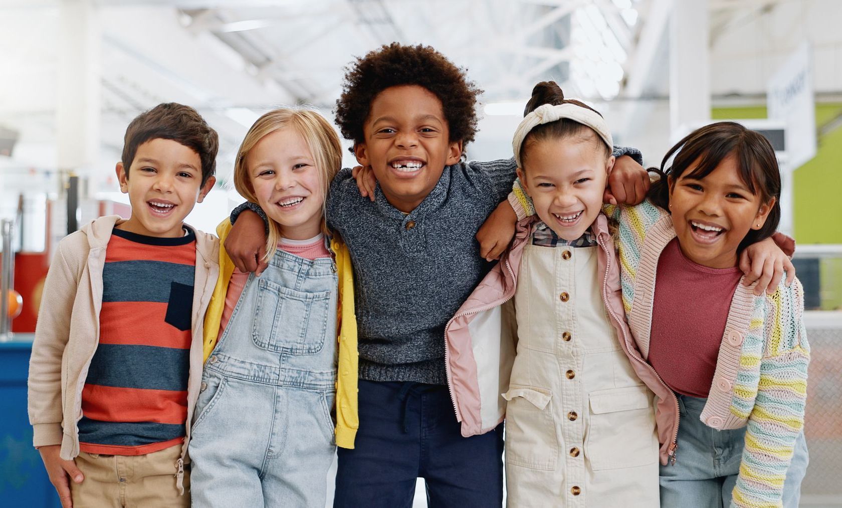 A group of children are posing for a picture together and smiling