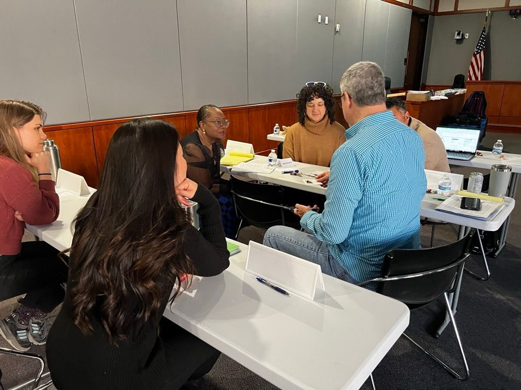 A group of people are sitting at tables in a room.