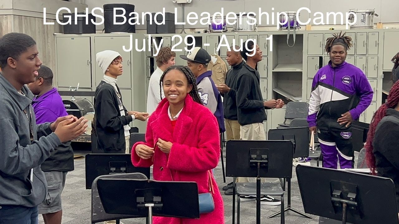 A girl in a red coat is standing in front of a band.