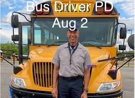 A man is standing in front of a yellow school bus.