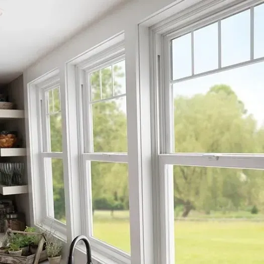 A kitchen with a lot of windows and a sink.