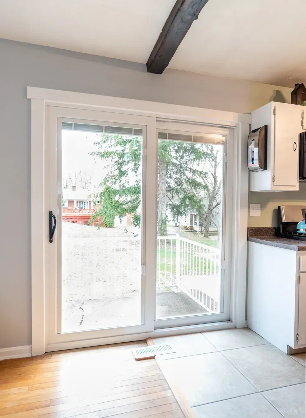 A kitchen with a sliding glass door leading to a deck.