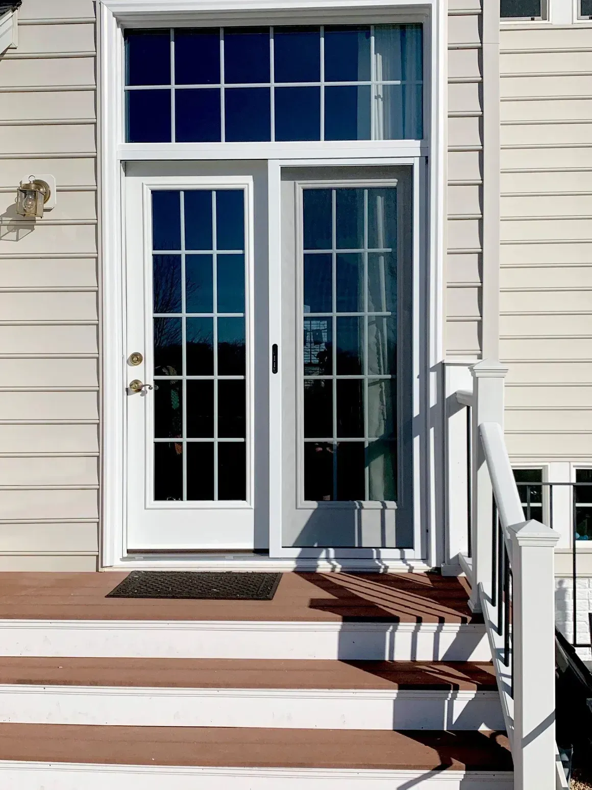 A white house with a french door and stairs