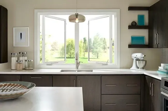 A kitchen with a sink and a large window.