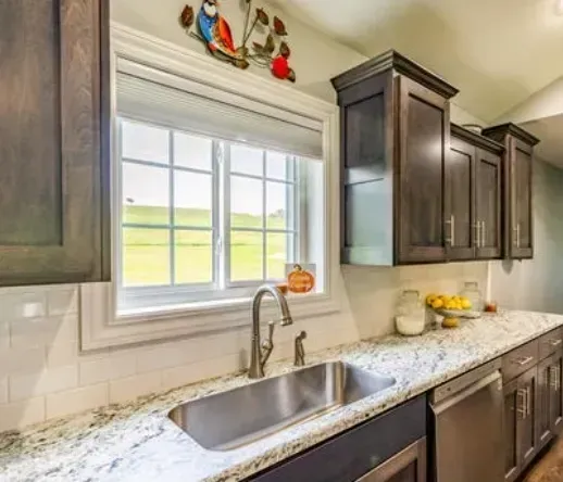 A kitchen with a sink and a large window in Damascus, AR for Window Replacement Companies photos