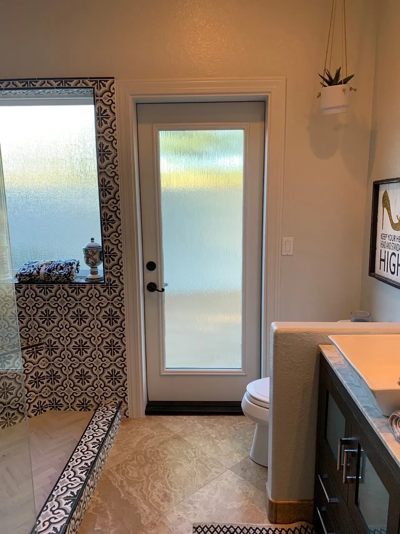 A bathroom with a toilet , sink , and shower.