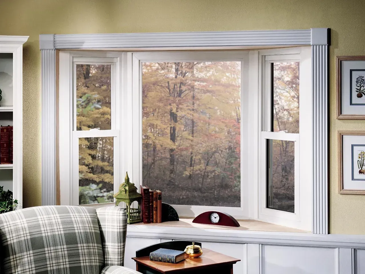 A living room with a bay window and a chair