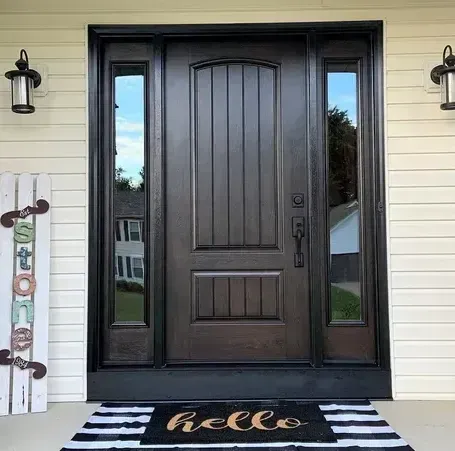 A door with a welcome mat in front of it