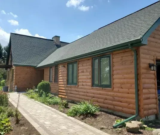 A log cabin with a walkway leading to it