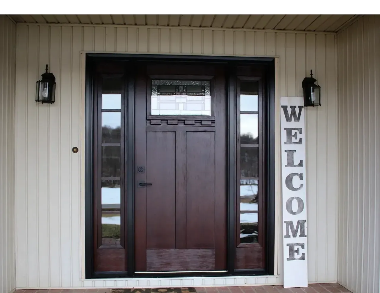 A brown door with a welcome sign in front of it