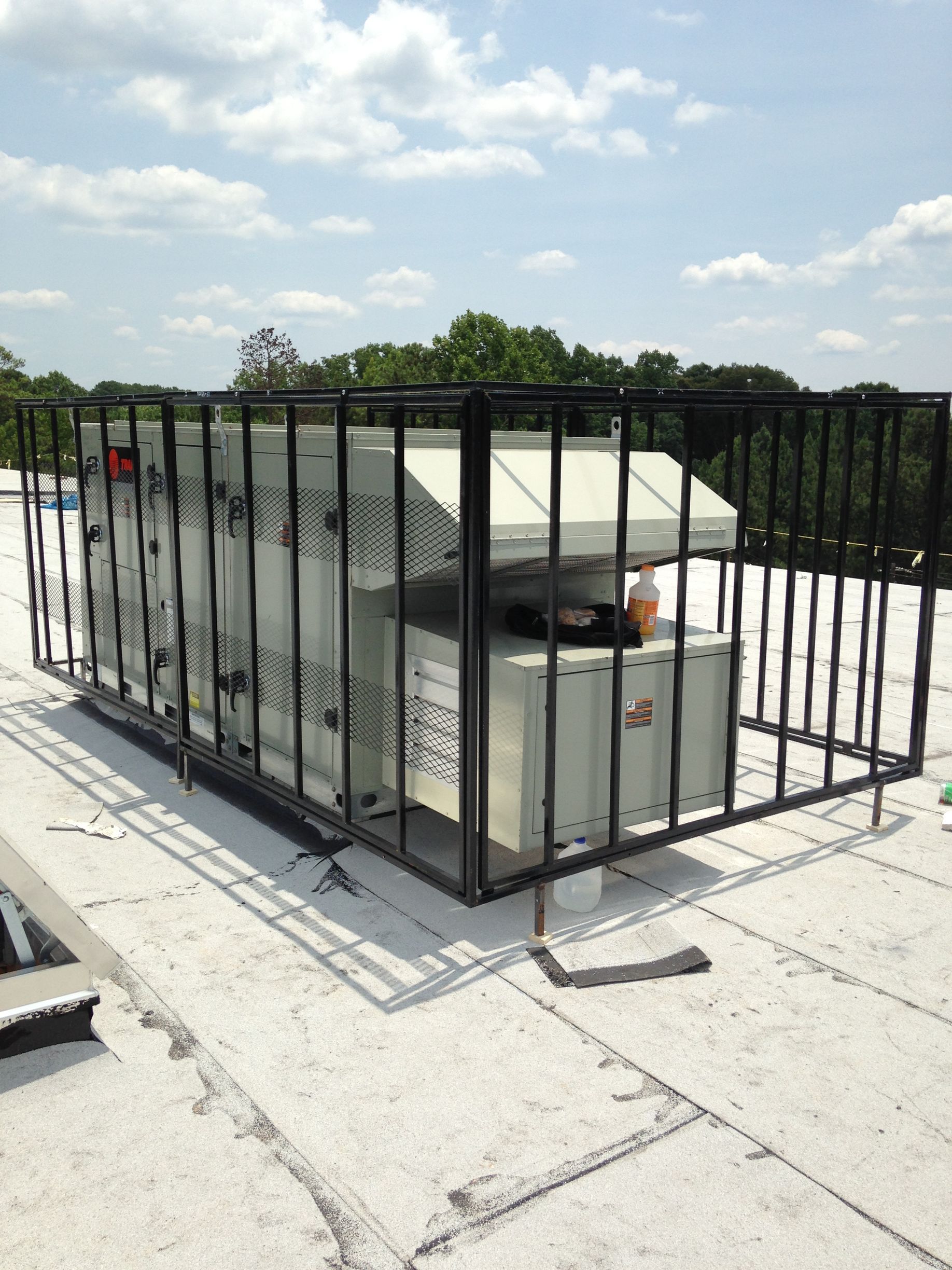 A rooftop with a metal fence around it