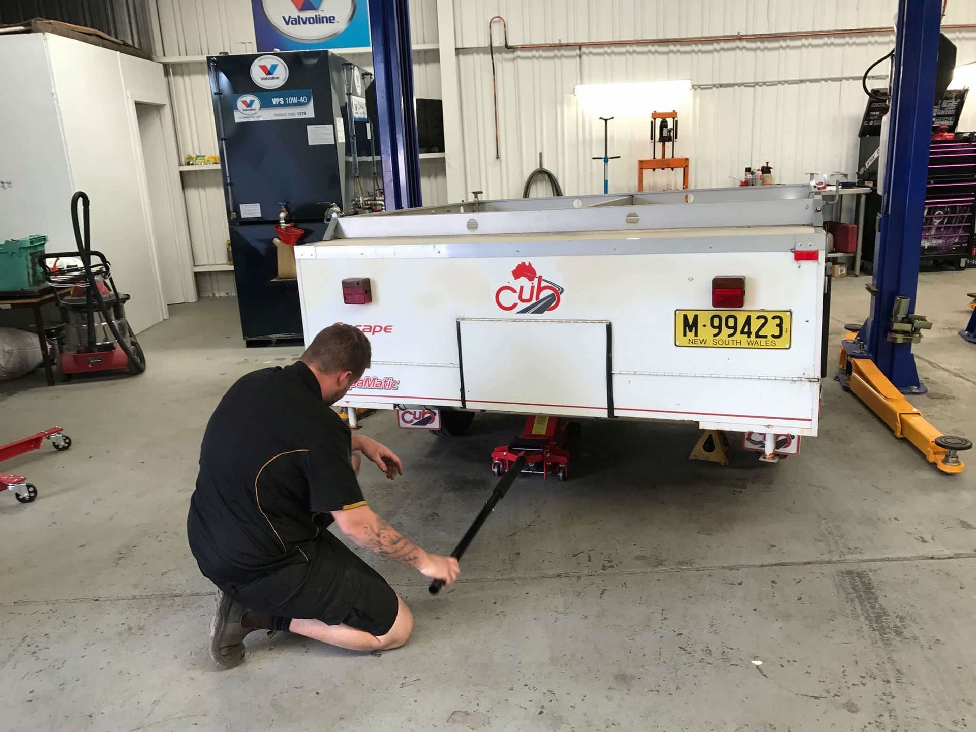 A Man Is Working On A Trailer — Sojos Mechanical & Tyre Service In West Gosford, NSW