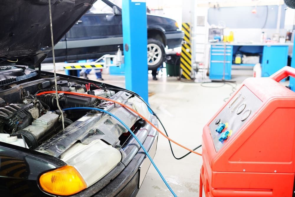A Car Is Being Serviced In A Garage With The Hood Open — Sojos Mechanical & Tyre Service In West Gosford, NSW
