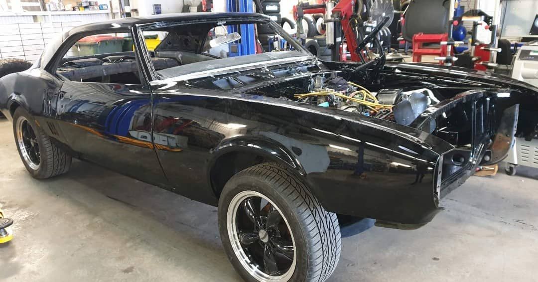 A Black Car Is Being Restored In A Garage — Sojos Mechanical & Tyre Service In West Gosford, NSW