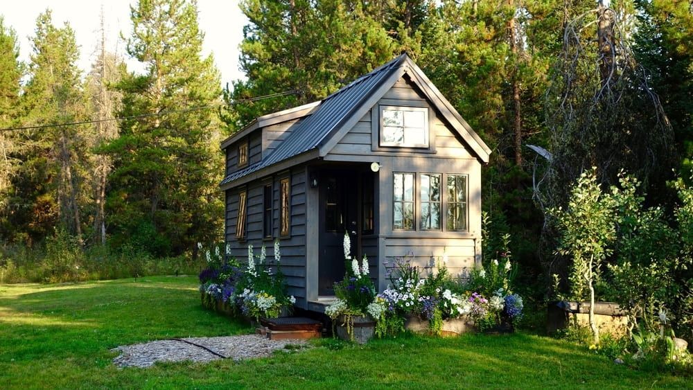 A Small House Is Sitting In The Middle Of A Lush Green Field — Sojos Mechanical & Tyre Service In Wyoming, NSW