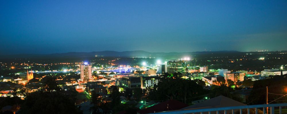 City Skyline at Night With Bright Lights Across a Valley Under a Dark Sky — Accredited Training in Ipswich, QLD