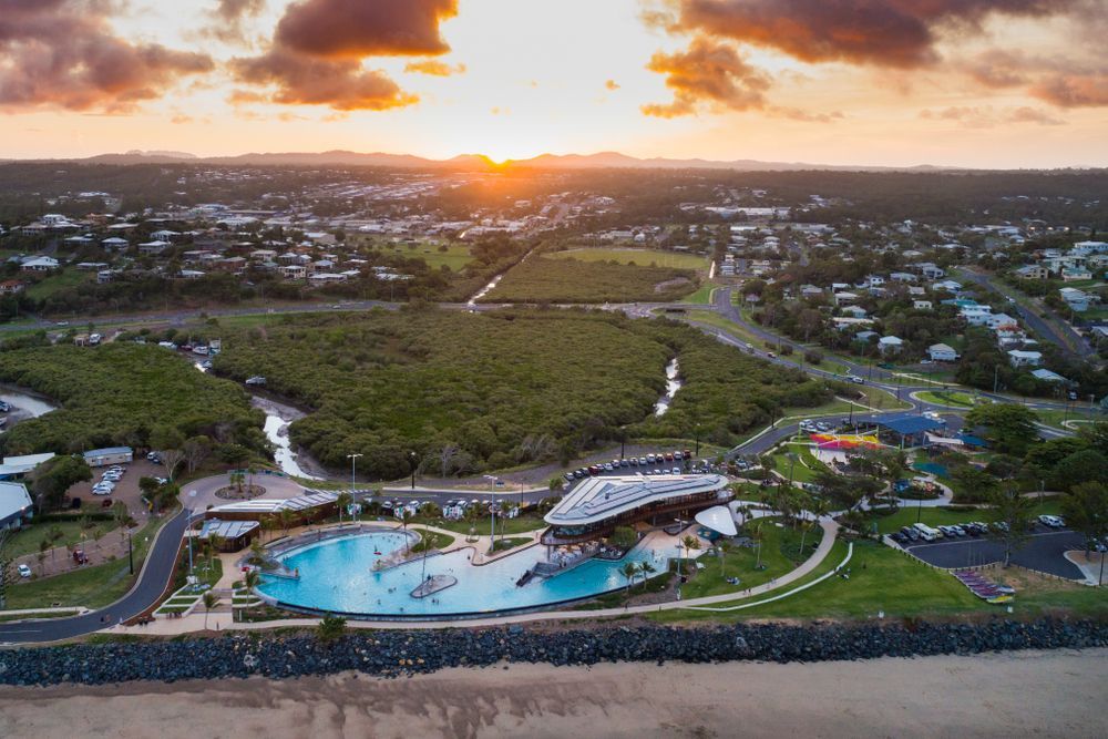 Aerial View of a Beachfront Resort With a Large Pool at Sunset and the Ocean — Accredited Training in Livingstone, QLD