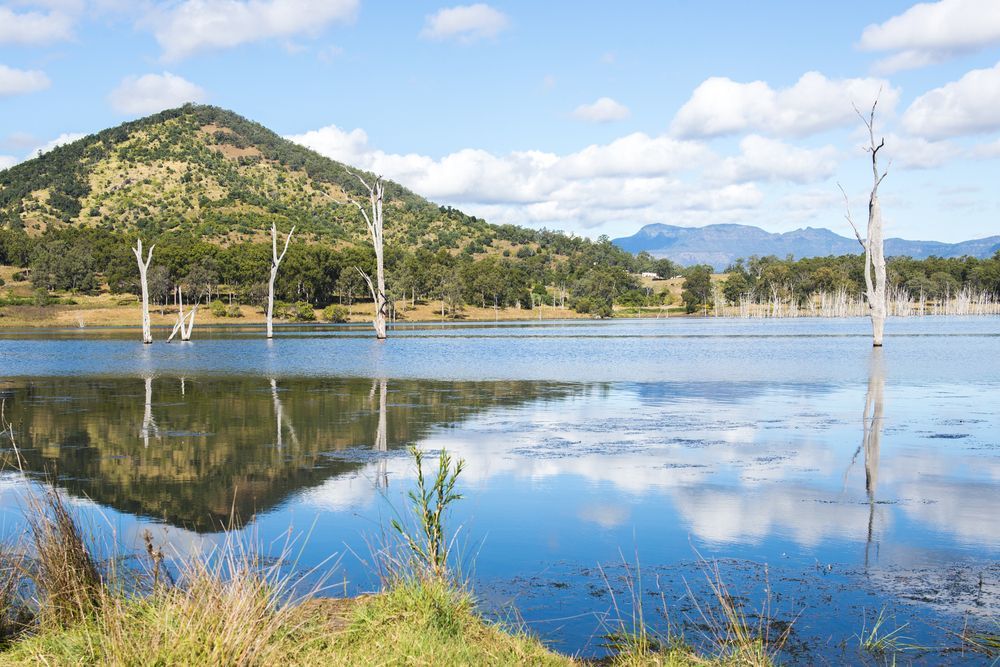 Serene Lake Reflecting Mountains, Trees, and Blue Sky With Clouds — Accredited Training in Scenic Rim, QLD