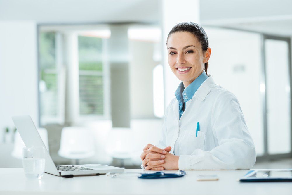 Female Doctor at Office Desk — Accredited Training in Rockhampton QLD Female Doctor at Office Desk — Accredited Training in Rockhampton QLD