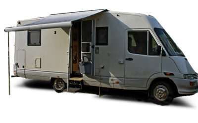 Gray camper van with awning extended and side door open, showing the interior