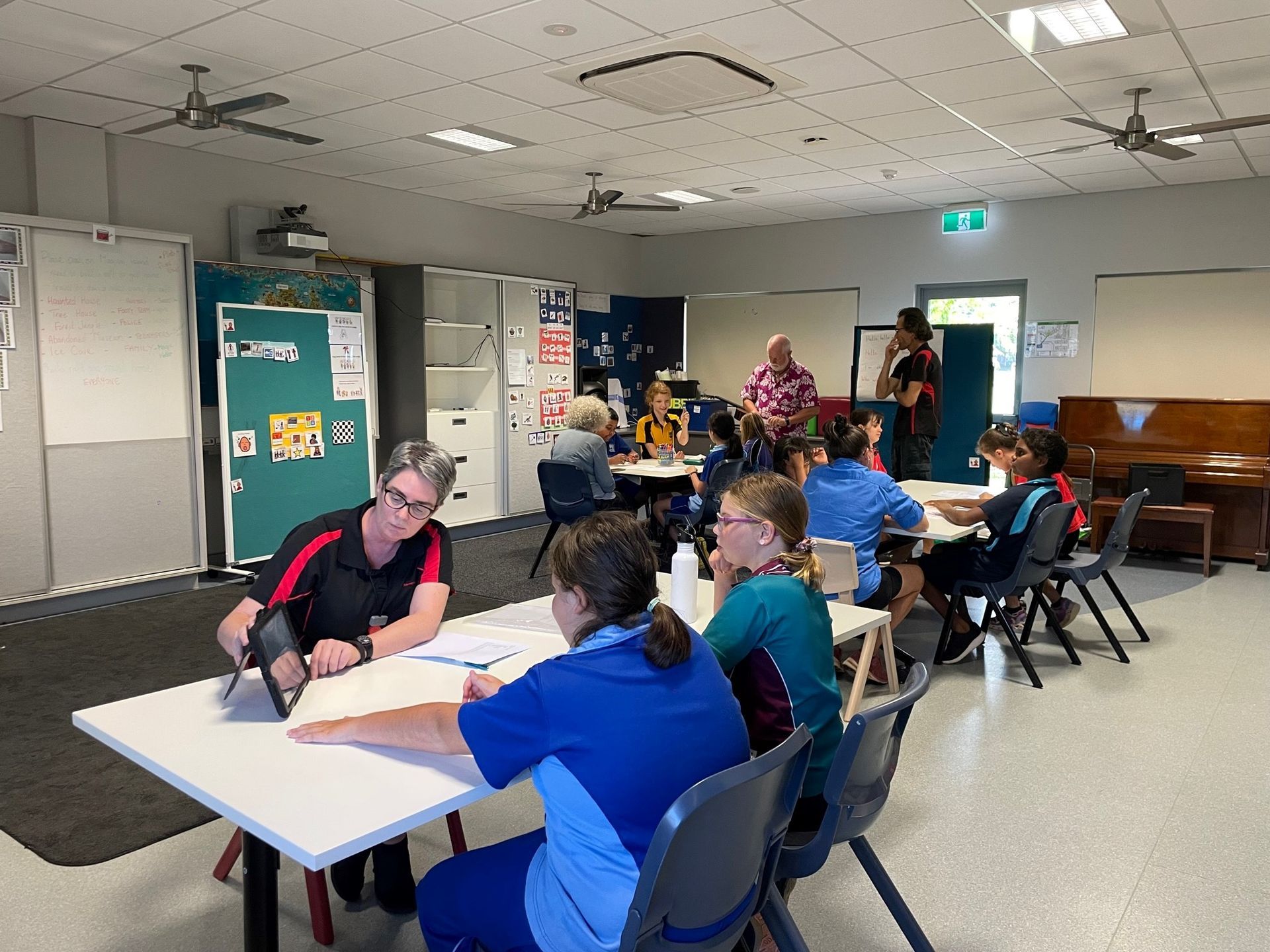 A group of people are sitting at tables in a room.