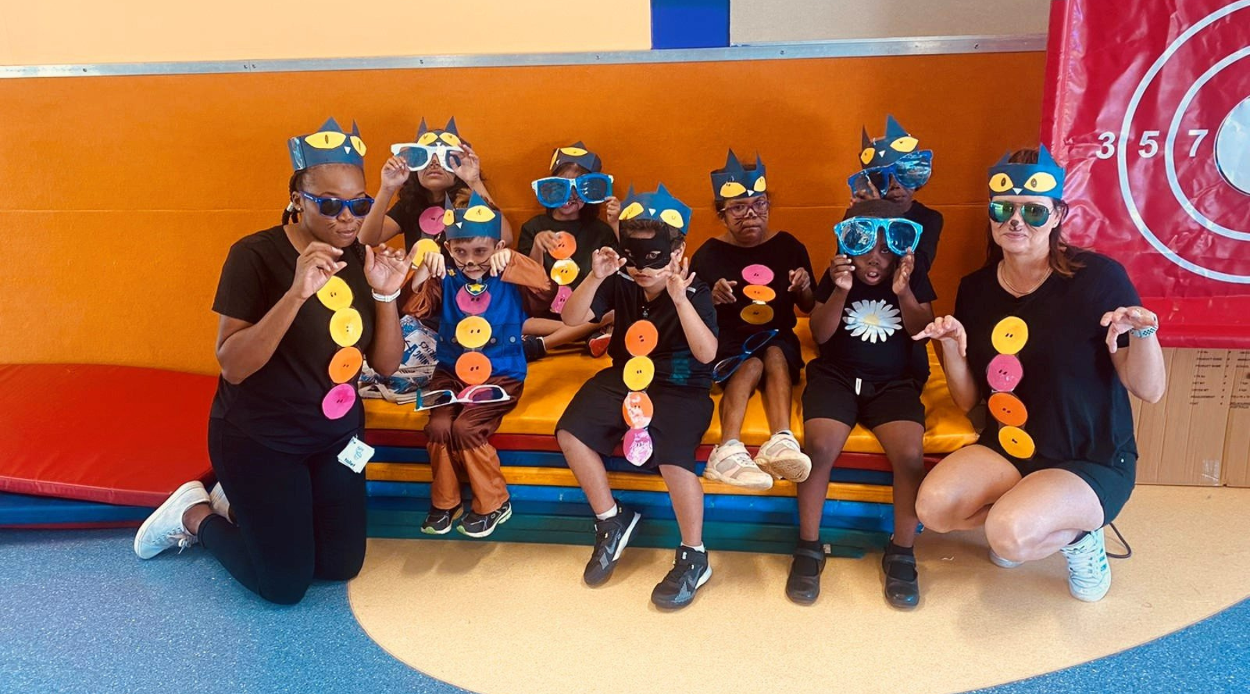 A group of children wearing sunglasses are posing for a picture